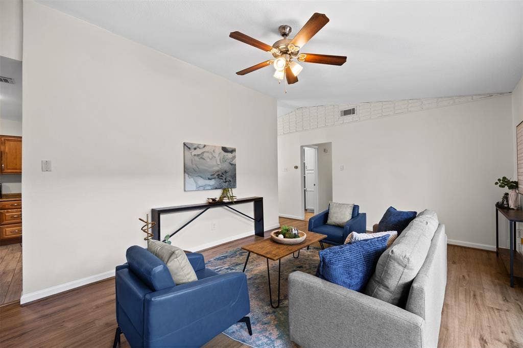 1118 Pacific Drive, Richardson, TX 75081 Vaulted ceiling with a ceiling fan, wood-finish flooring, and neutral wall tones