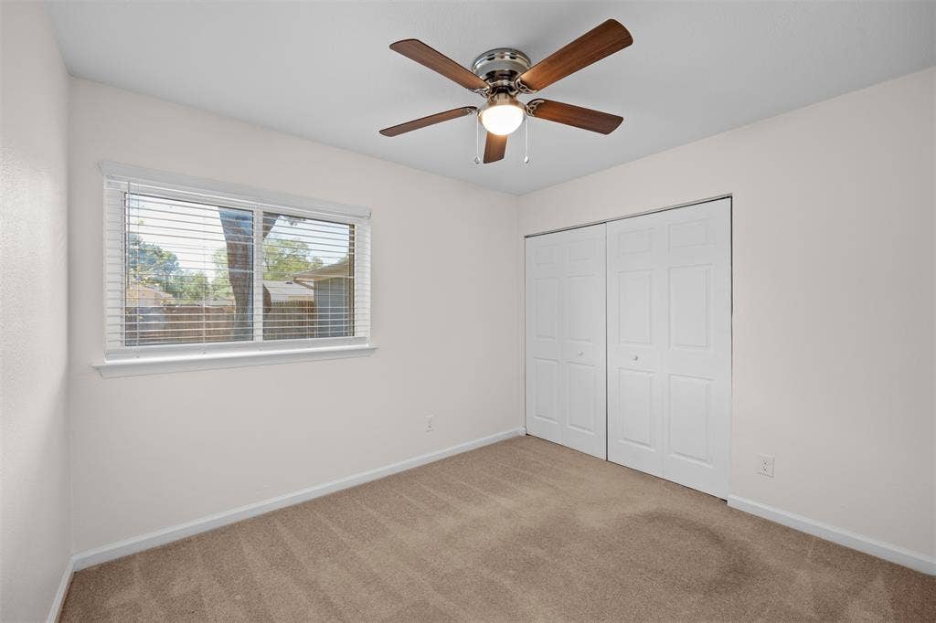 1118 Pacific Drive, Richardson, TX 75081 Neutral-toned carpet flooring, white walls, and a window with blinds provide natural light