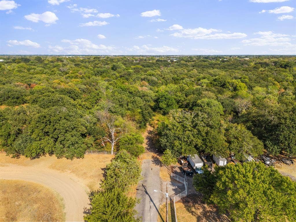 19 No Name Street, Dallas, TX 75217 Expansive treed landscape with a paved road and natural terrain