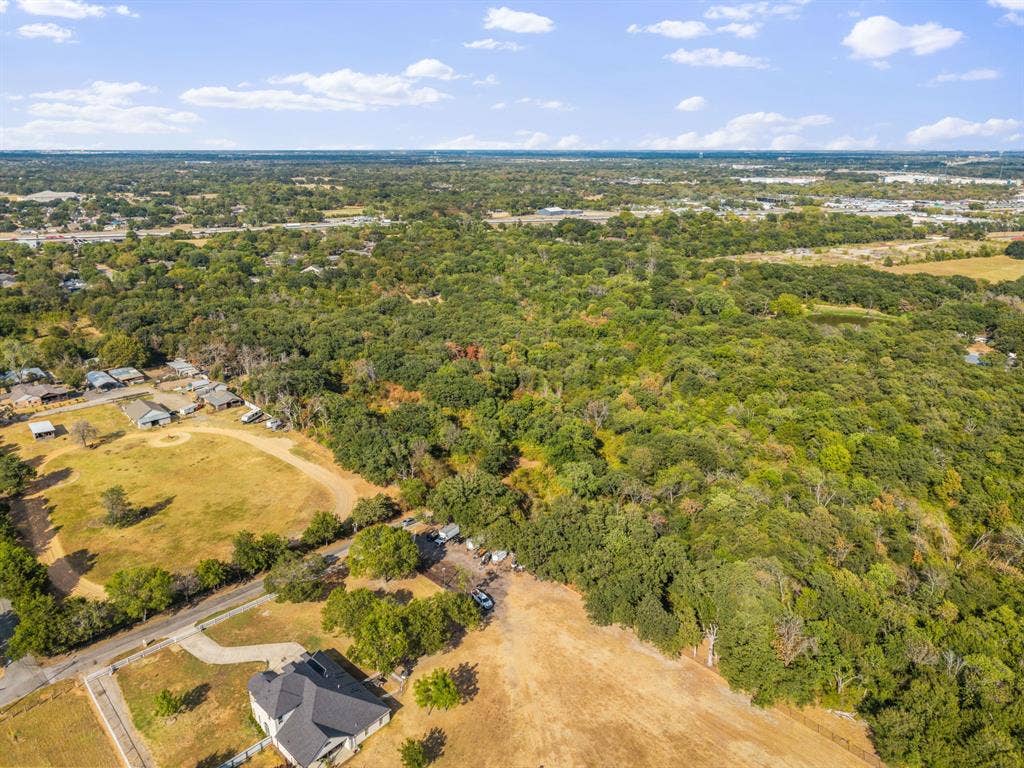 19 No Name Street, Dallas, TX 75217 Expansive wooded acreage featuring diverse tree cover and level clearings