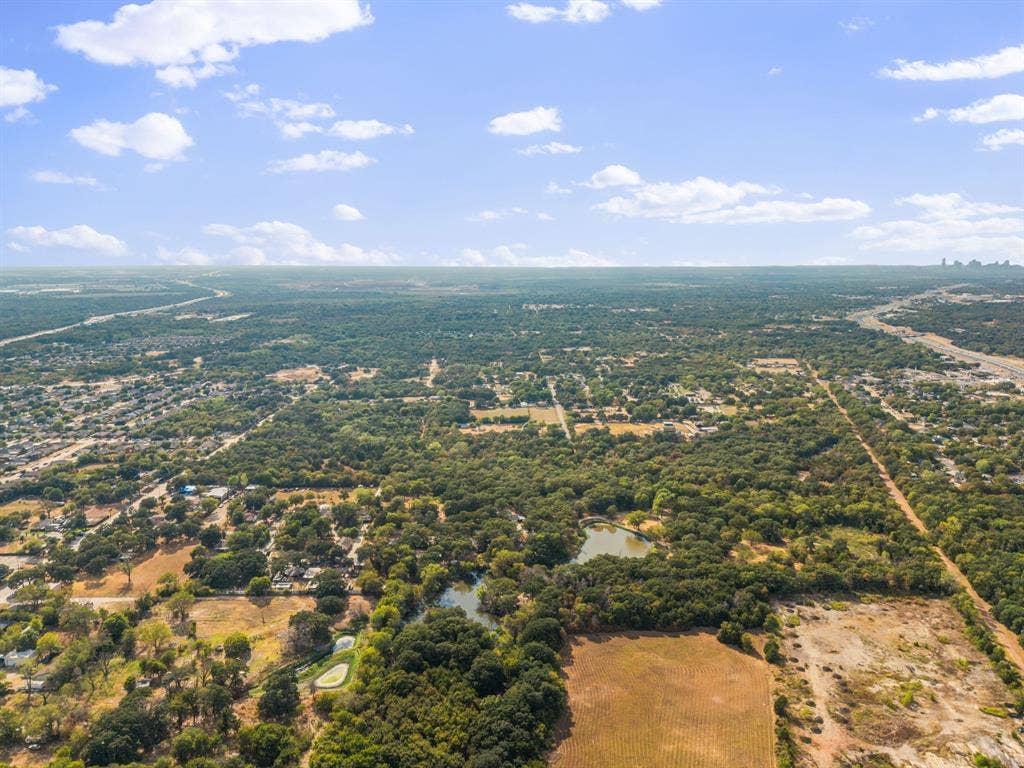 19 No Name Street, Dallas, TX 75217 Expansive treed landscape with a visible body of water, offering broad natural surroundings and distant urban features