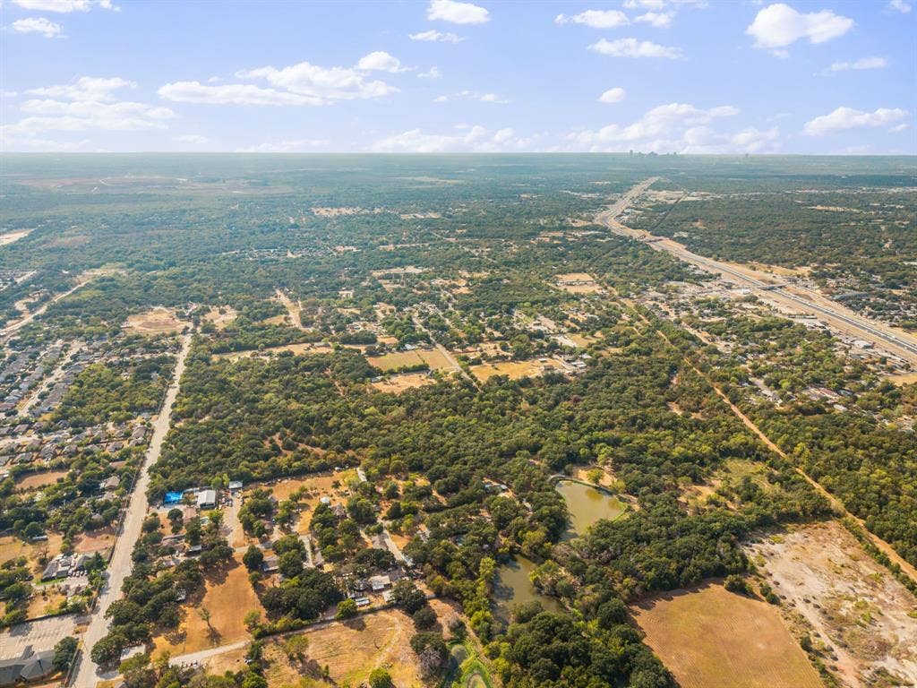 19 No Name Street, Dallas, TX 75217 Expansive aerial view showcasing a large body of water, extensive tree coverage, and an established residential area