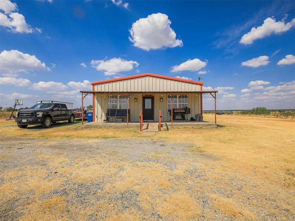 16880 W Fm 455, Celina, TX 75009 Metal-sided structure featuring a covered front porch and red-finish roof