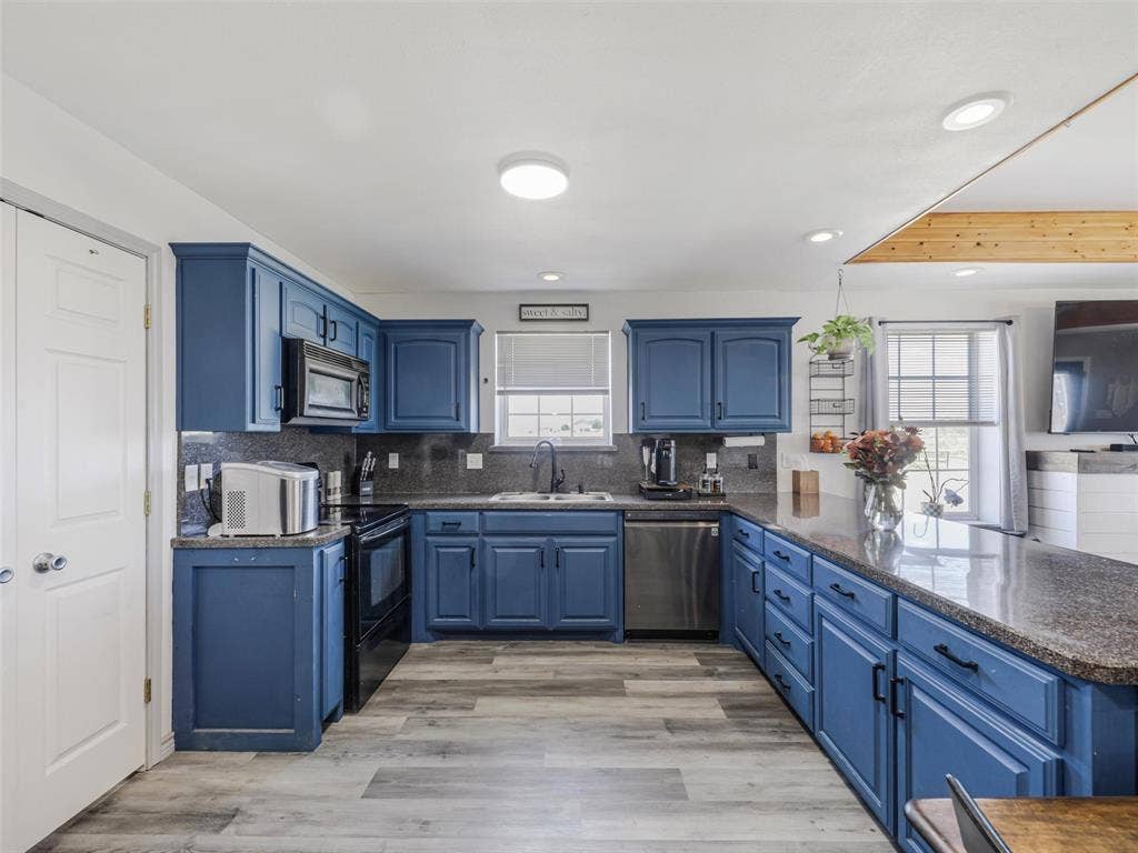 16880 W Fm 455, Celina, TX 75009 Kitchen featuring blue cabinetry, dark countertops, wood-finish flooring, recessed lighting, and a stainless steel dishwasher