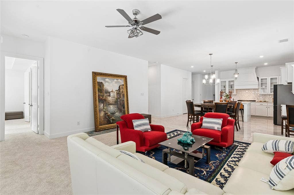 Open concept living area with recessed lighting, ceiling fan, and carpeted flooring