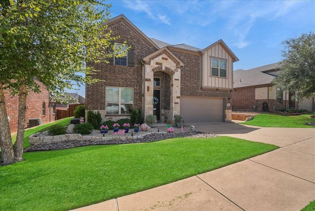 2206 Wellington Lane, Corinth, TX 76210 Beautiful curb appeal enhanced by decorative stonework, river rock and landscaped flower beds.