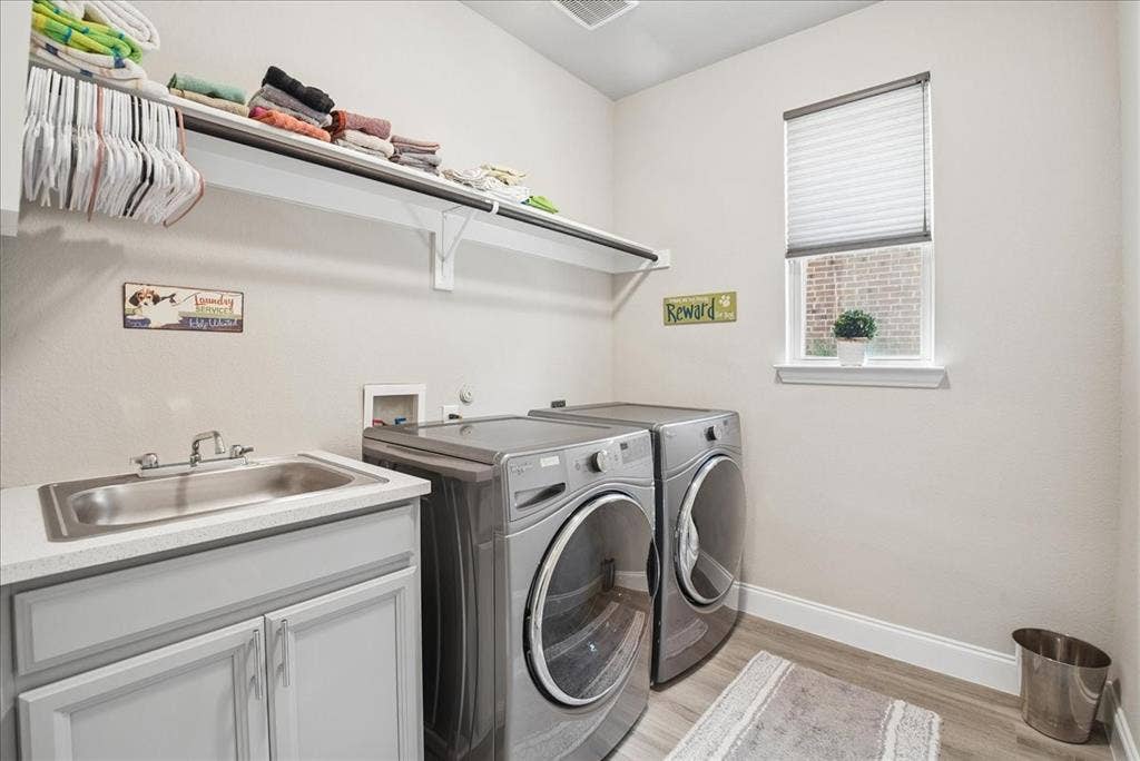 2206 Wellington Lane, Corinth, TX 76210 Convenient first-floor laundry room with utility sink, storage and natural light.