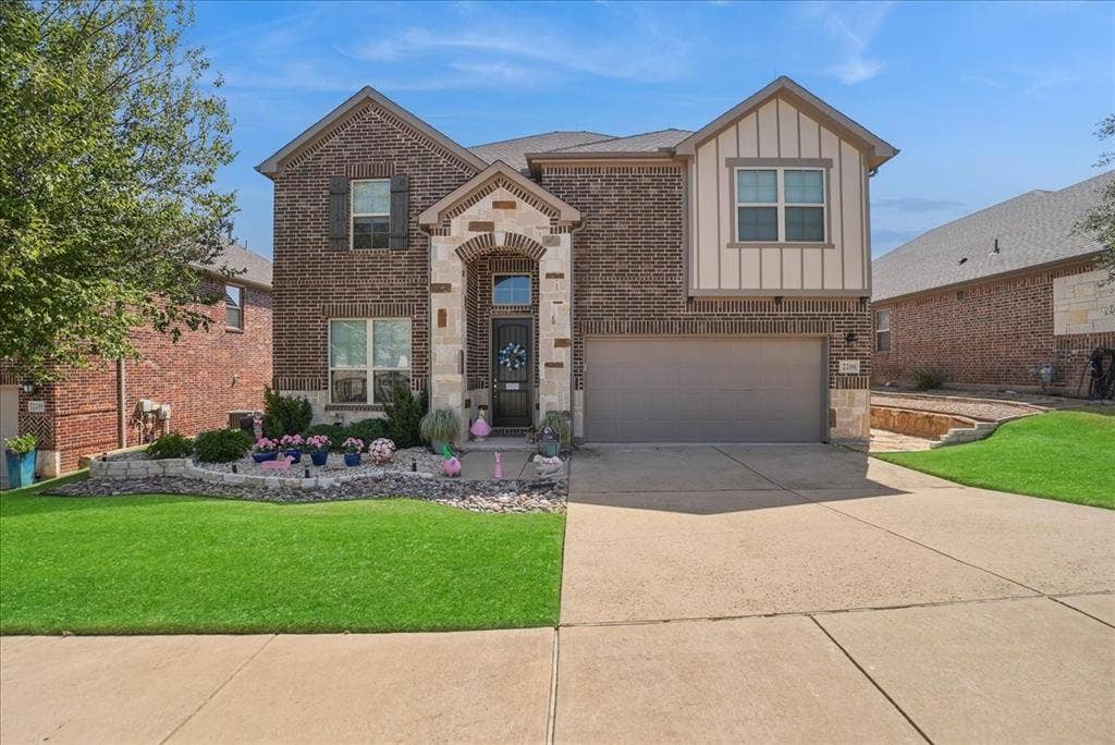 2206 Wellington Lane, Corinth, TX 76210 Striking brick and stone exterior with manicured landscaping and beautiful curb appeal!