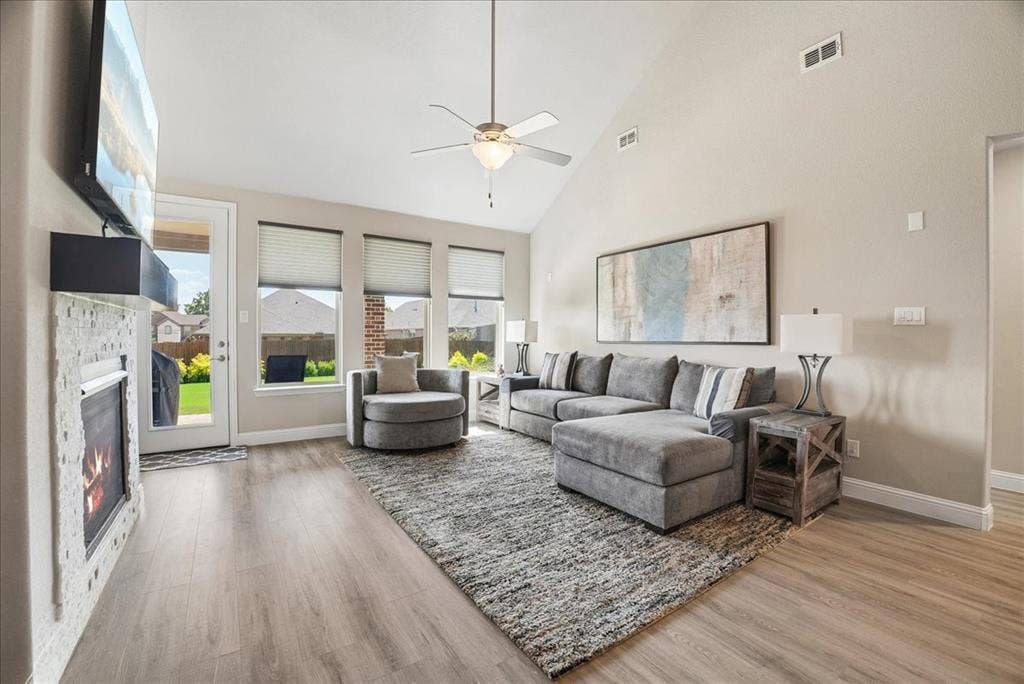 2206 Wellington Lane, Corinth, TX 76210 Abundant space and light in the vaulted living room with beautiful views of the lush backyard.