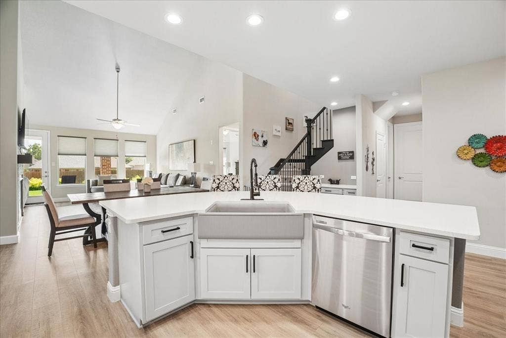 2206 Wellington Lane, Corinth, TX 76210 Oversized island with beautiful quartz countertops, farmhouse sink and abundant workspace.