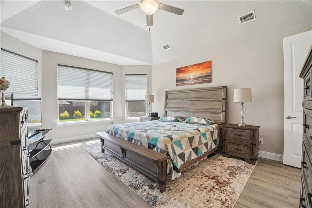 2206 Wellington Lane, Corinth, TX 76210 Spacious primary bedroom with vaulted ceiling and abundant natural light.