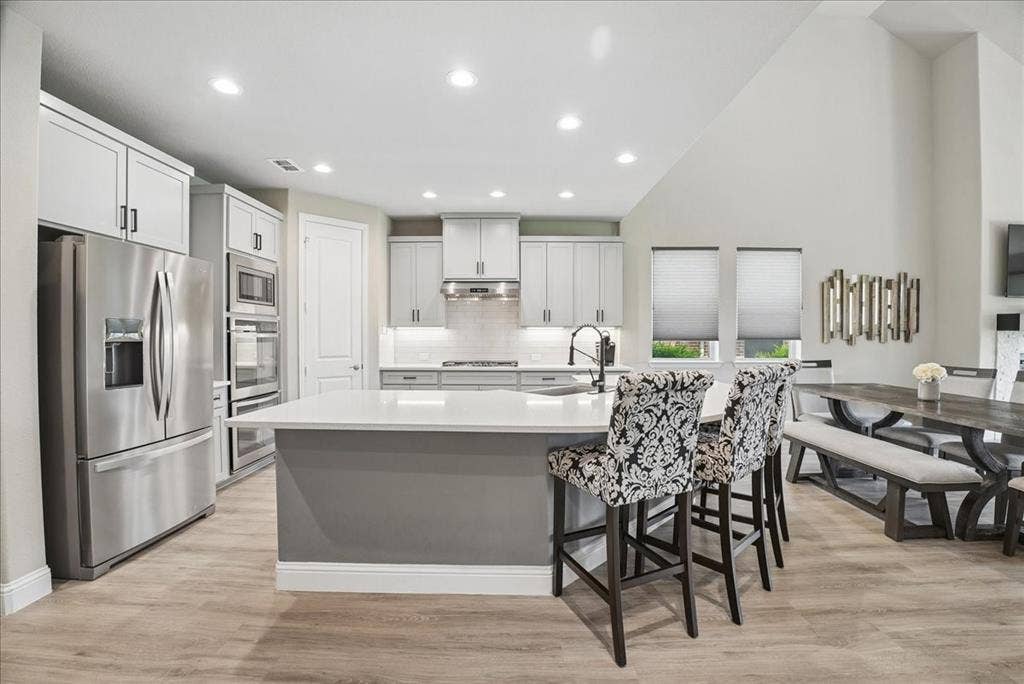 2206 Wellington Lane, Corinth, TX 76210 Oversized island, stainless steel appliances and spacious dining area.