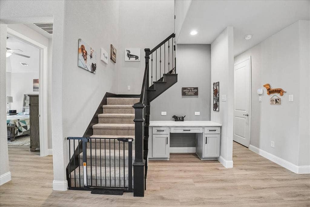 2206 Wellington Lane, Corinth, TX 76210 Stylish staircase with built-in workspace and modern finishes.