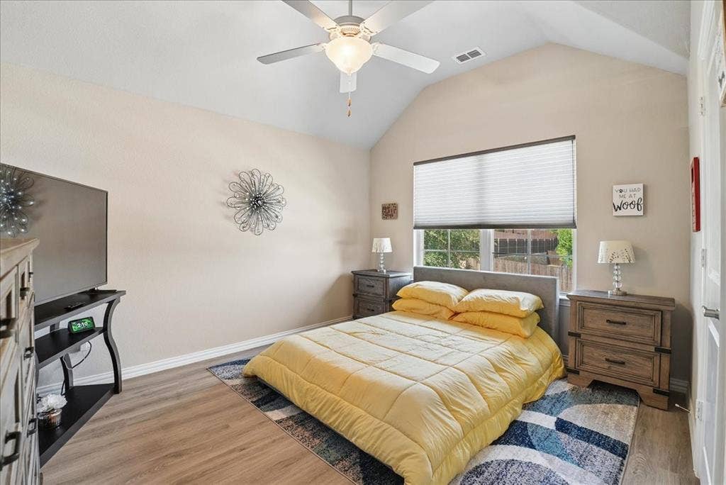 2206 Wellington Lane, Corinth, TX 76210 Spacious secondary bedroom with vaulted ceiling, natural light and private en-suite bath.
