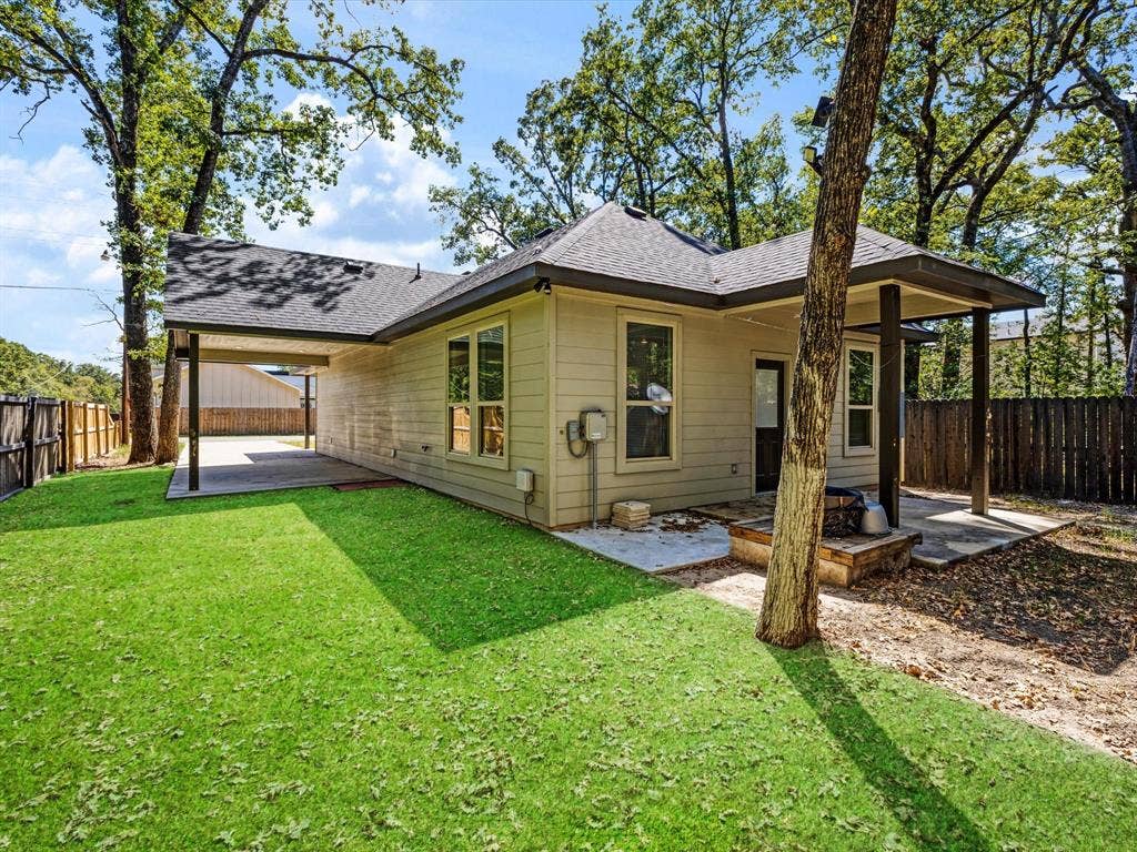 82 Indian Harbor Drive, Mabank, TX 75156 Covered patio, additional covered parking area, private backyard with privacy fencing, and mature trees