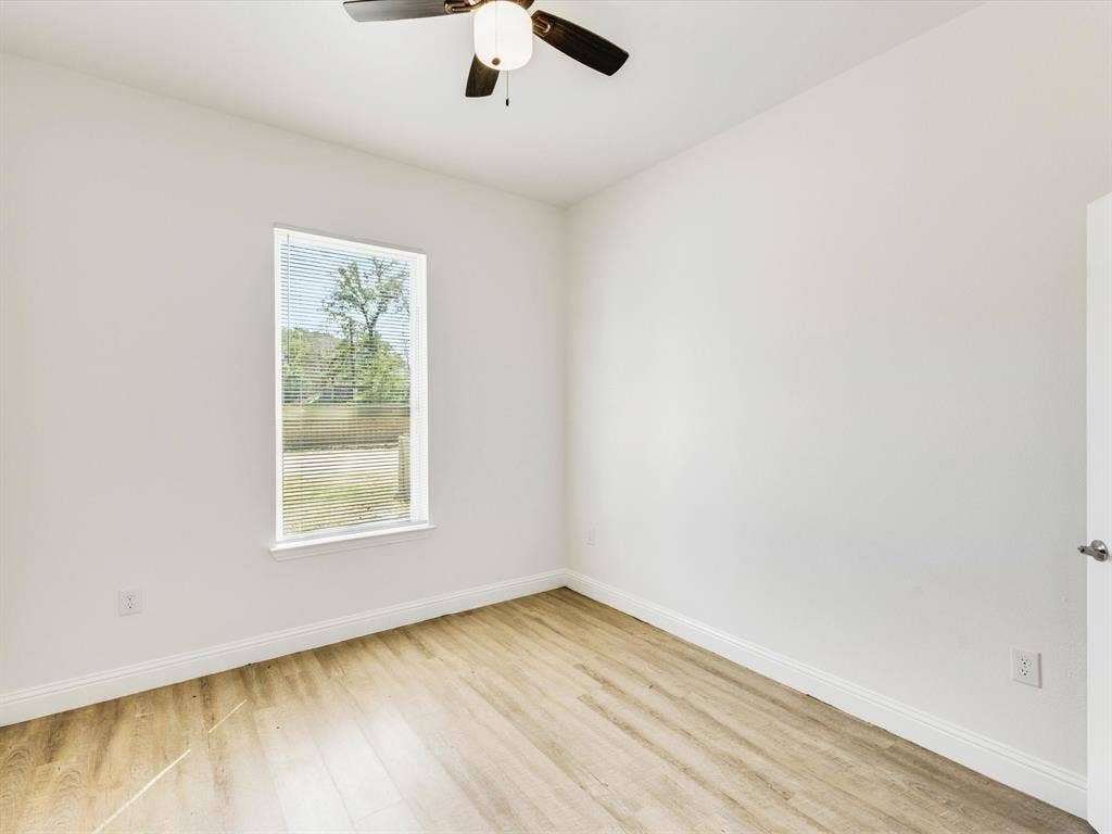 82 Indian Harbor Drive, Mabank, TX 75156 Light-filled room featuring wood-finish flooring, a ceiling fan, and white walls