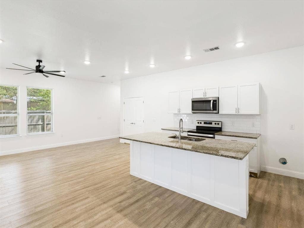 82 Indian Harbor Drive, Mabank, TX 75156 Open-concept living space featuring wood-finish flooring and recessed lighting