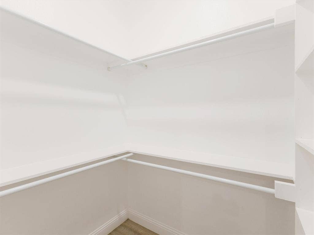 82 Indian Harbor Drive, Mabank, TX 75156 White-painted walls and shelving system featuring multiple hanging rods