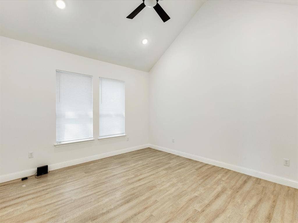 82 Indian Harbor Drive, Mabank, TX 75156 Vaulted ceiling with a ceiling fan, recessed lighting, two windows with blinds, and wood-finish flooring