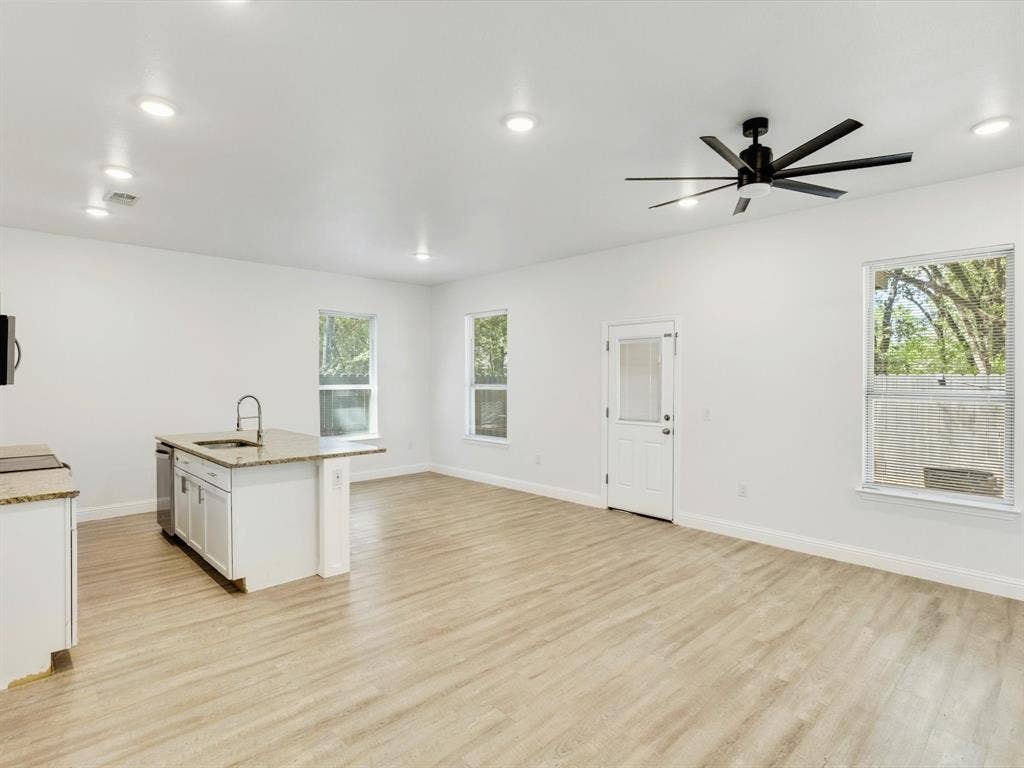 82 Indian Harbor Drive, Mabank, TX 75156 Open-concept living area featuring wood-finish flooring, recessed lighting, and a contemporary ceiling fan