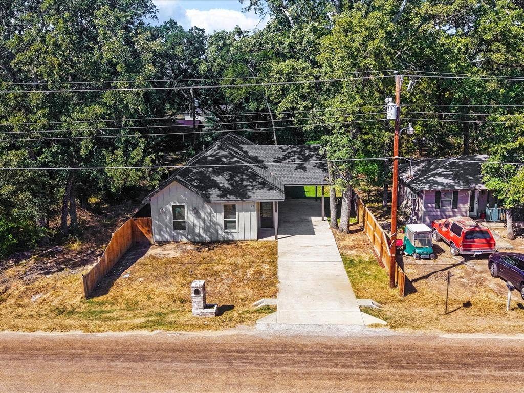 82 Indian Harbor Drive, Mabank, TX 75156 Single-story residence featuring a gray exterior, a dark shingle roof, and multiple windows