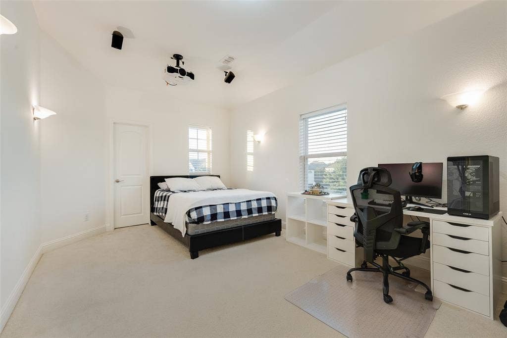2408 Brisbane Lane, Plano, TX 75075 Recessed ceiling-mounted projector, integrated ceiling speakers, dual windows with blinds, wall-mounted sconce lighting, and soft carpet flooring