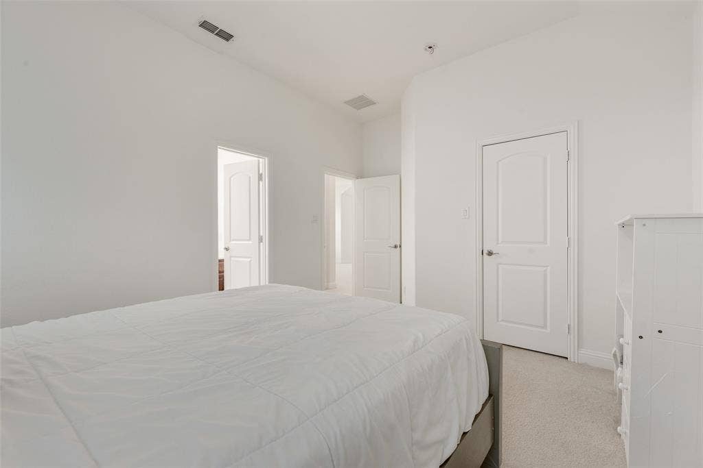 2408 Brisbane Lane, Plano, TX 75075 Vaulted ceiling, arched panel doors, and neutral carpeting