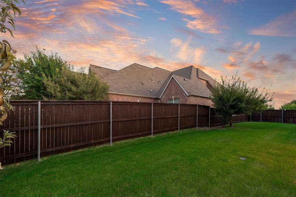 2408 Brisbane Lane, Plano, TX 75075 Expansive green lawn with a privacy fence