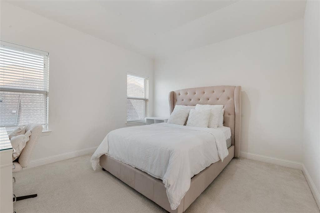 2408 Brisbane Lane, Plano, TX 75075 Light-toned carpet flooring, two windows with horizontal blinds, and clean white wall finishes