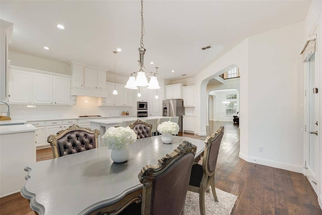 2408 Brisbane Lane, Plano, TX 75075 Spacious kitchen featuring white cabinetry, light countertops, subway tile backsplash, and stainless steel appliances