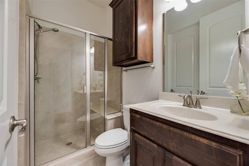 2408 Brisbane Lane, Plano, TX 75075 2nd Bathroom Downstairs. Bathroom for 2nd Downstairs Bedroom. Glass-enclosed shower with tiled walls and flooring