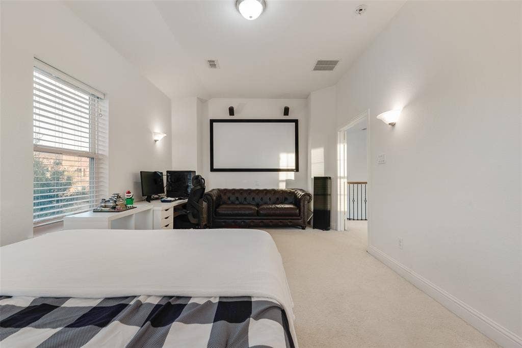 2408 Brisbane Lane, Plano, TX 75075 Wall-mounted projection screen, recessed lighting, and sconce lighting fixtures illuminate this carpeted room