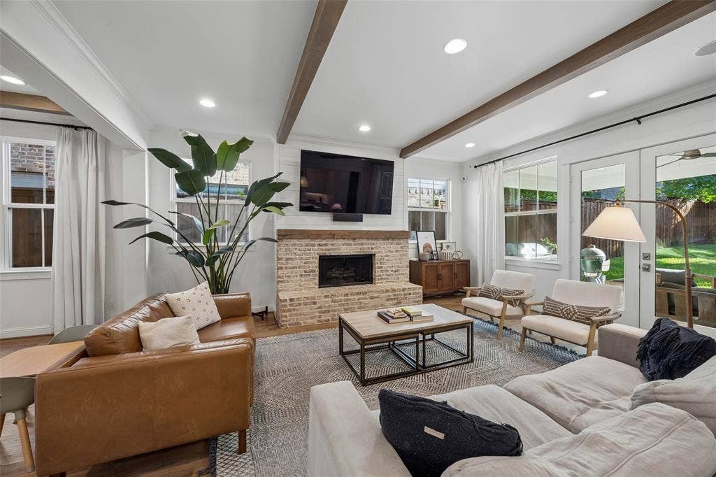 7318 Casa Loma Avenue, Dallas, TX 75214 Main floor living room with cozy gas fireplace. French doors open to the covered rear patio for seamless entertaining