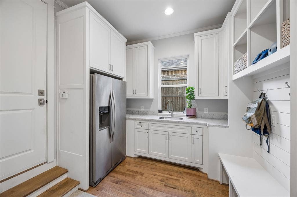 7318 Casa Loma Avenue, Dallas, TX 75214 Oversized mudroom with plenty of storage, a separate refrigerator and sink. Direct access to the garage.