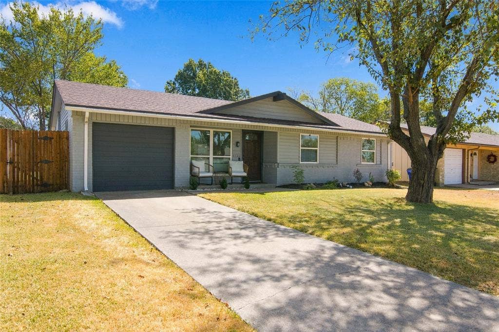 4720 Kyle Drive, Balch Springs, TX 75180 Single-story residence featuring a two-car garage, concrete driveway, and a front porch