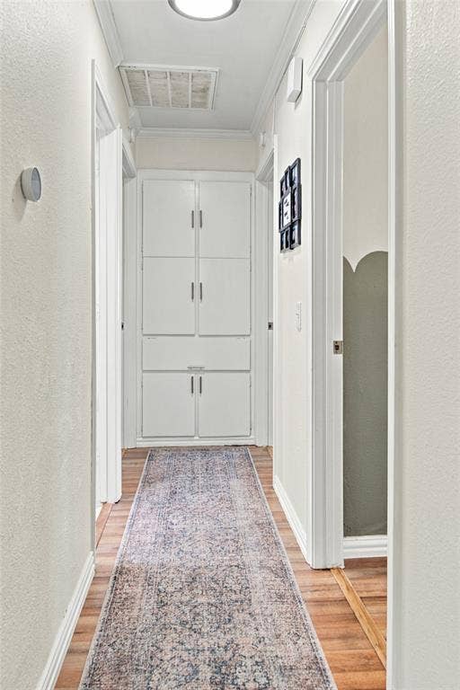 4720 Kyle Drive, Balch Springs, TX 75180 Wood-finish flooring throughout, featuring built-in white cabinetry, crown molding, and recessed lighting