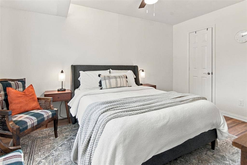 4720 Kyle Drive, Balch Springs, TX 75180 Wood-finish flooring, ceiling fan, white paneled door, and neutral wall tones
