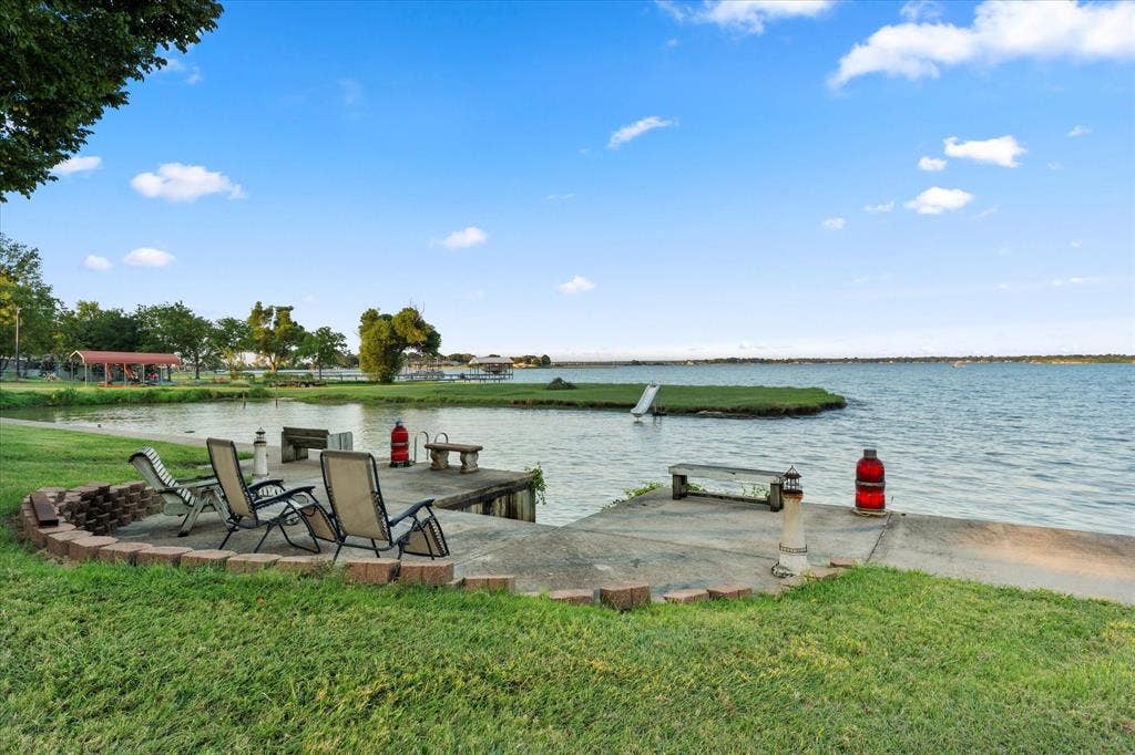 308 Causeway Cove, Seven Points, TX 75143 Waterside patio with concrete surface, brick-lined fire pit, and expansive waterfront access