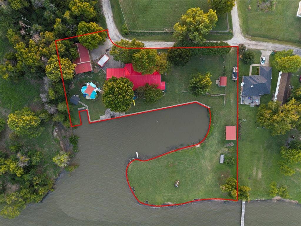 308 Causeway Cove, Seven Points, TX 75143 Expansive waterfront property featuring a dedicated dock, private pond, and large grassy areas