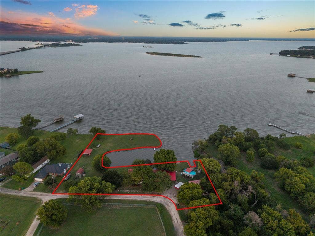 308 Causeway Cove, Seven Points, TX 75143 Expansive waterfront property featuring a private boat dock, dedicated pond, mature trees, a swimming pool, and a paved drive