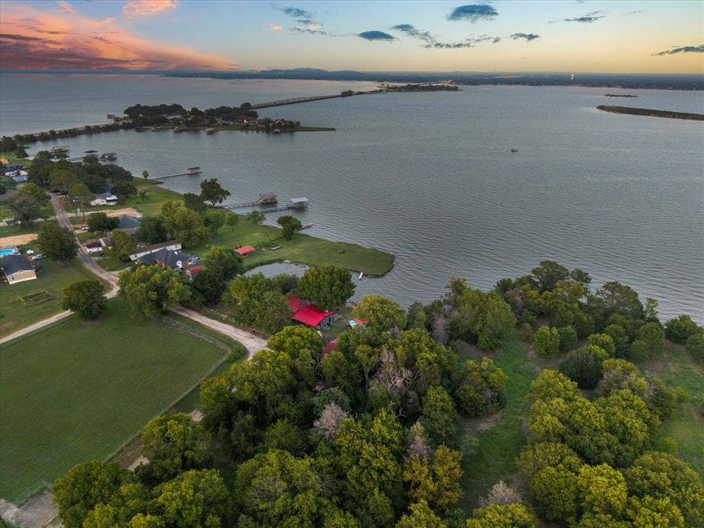 308 Causeway Cove, Seven Points, TX 75143 Expansive waterfront property featuring a substantial body of water, green spaces, and mature trees