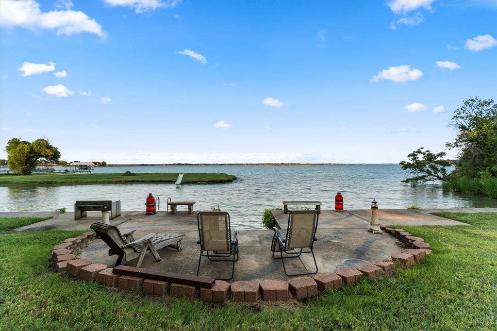 308 Causeway Cove, Seven Points, TX 75143 Concrete patio with brick paver border, featuring direct water access at full pool and a private dock