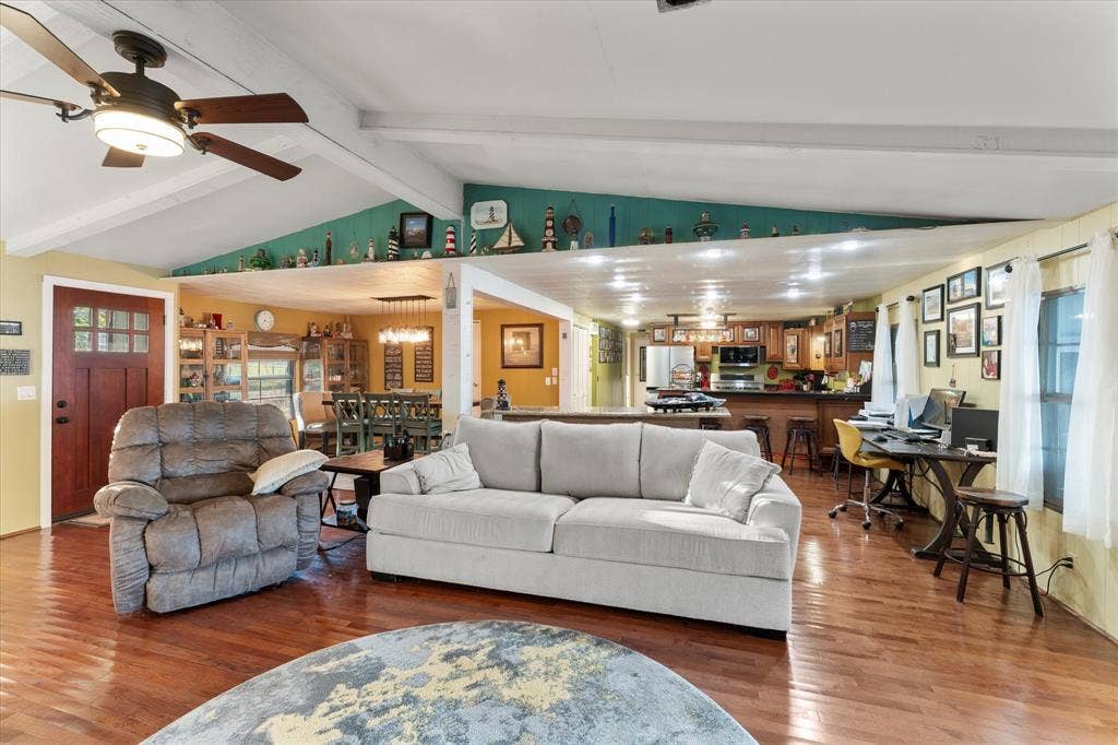 308 Causeway Cove, Seven Points, TX 75143 Vaulted ceiling with exposed beams, wood-finish flooring, recessed lighting, and kitchen area with built-in cabinetry