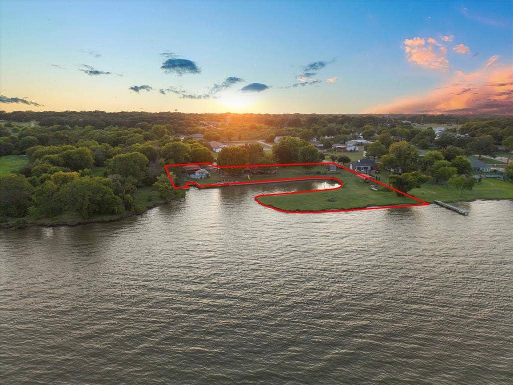 308 Causeway Cove, Seven Points, TX 75143 Waterfront property featuring a private dock, expansive grassy areas, mature trees, and a tranquil pond