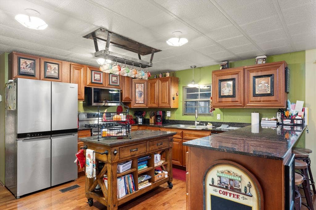 308 Causeway Cove, Seven Points, TX 75143 Wood-finish flooring with a multi-door stainless steel refrigerator