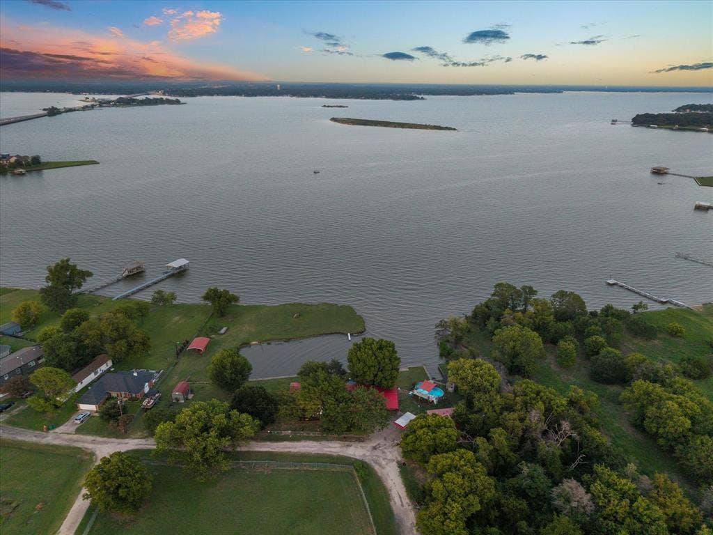 308 Causeway Cove, Seven Points, TX 75143 Waterfront property featuring multiple boat docks, a private pond, and expansive green spaces