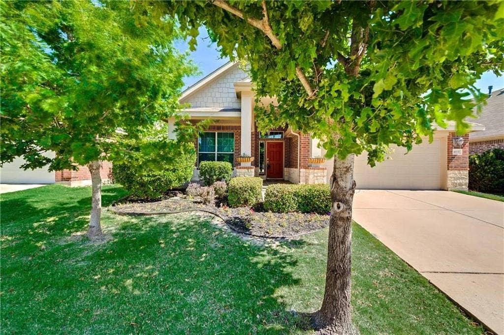 4637 Dwarf Nettle Drive, Fort Worth, TX 76244 Brick and stone exterior with a neutral garage door