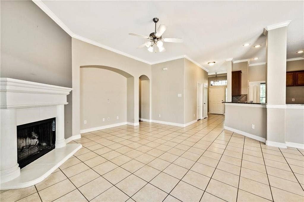 4637 Dwarf Nettle Drive, Fort Worth, TX 76244 Tile flooring, vaulted ceilings, a fireplace with a stone surround, recessed lighting, and a ceiling fan