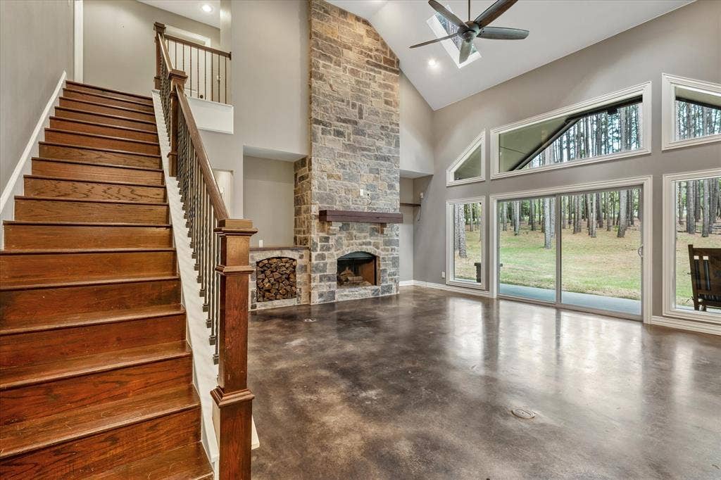 Family room with wood ready for the fireplace.