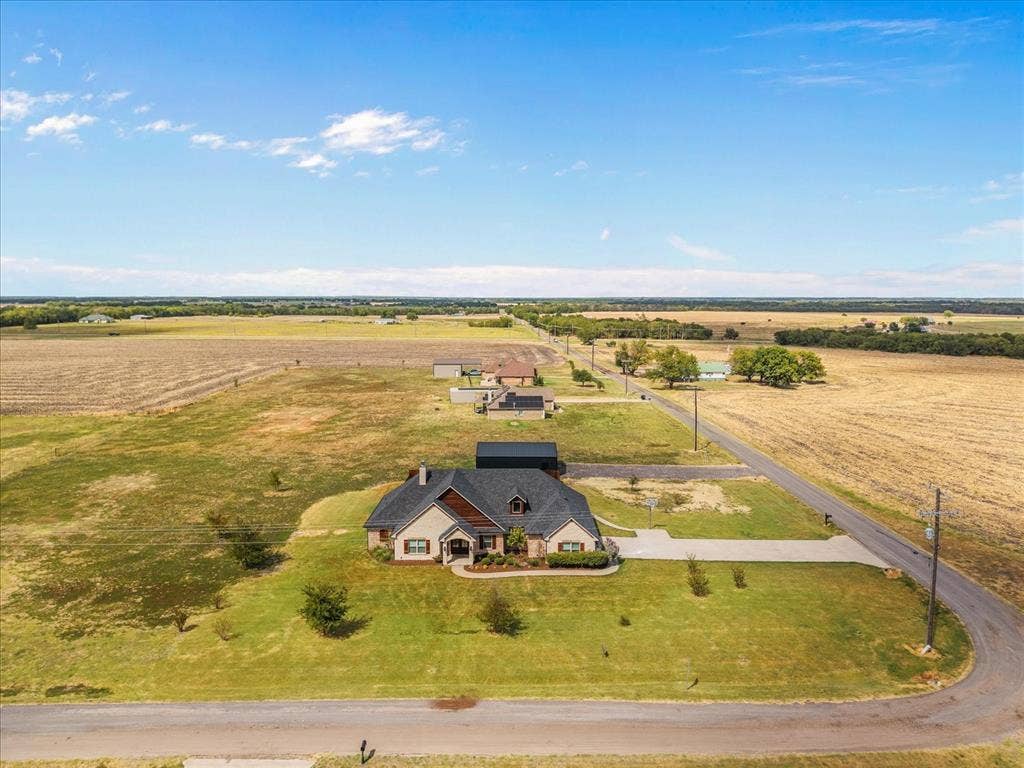 3674 County Road 2142, Caddo Mills, TX 75135 Single-story residence with a gabled roof, brick and siding exterior, and an attached garage